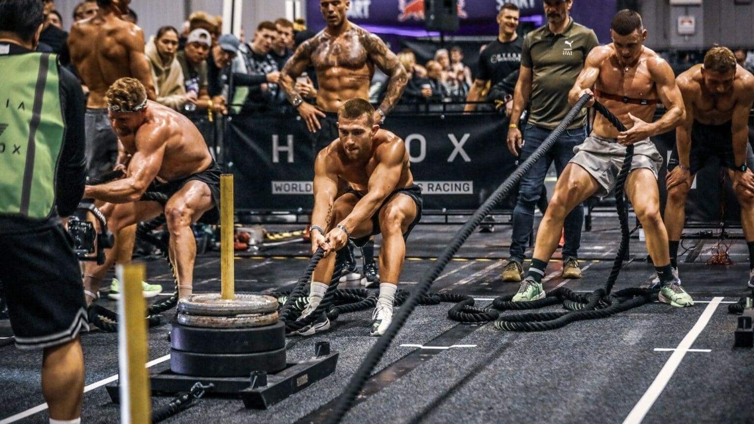 HYROX atleten tijdens sled pull en krachtonderdelen op wedstrijdniveau
